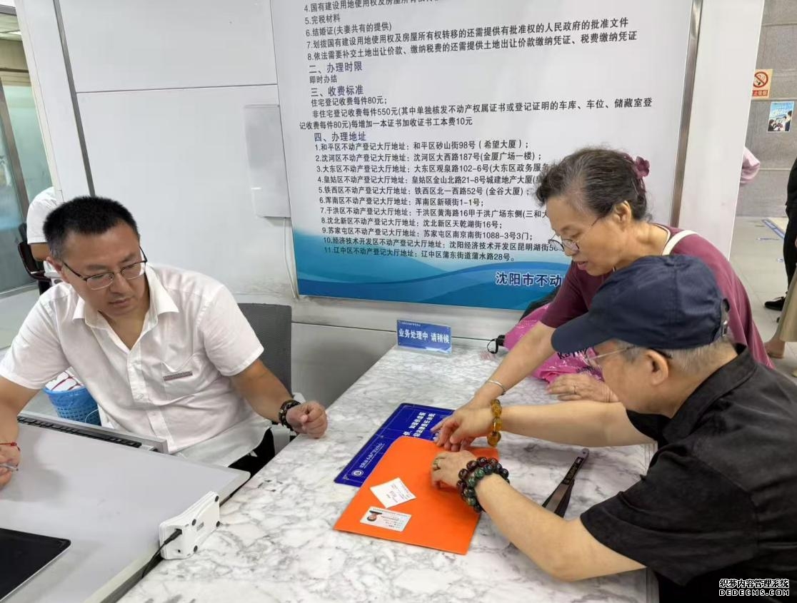 江先生和家人在沈阳市不动产登记中心办理房产证。办理单位供图